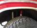 1986 Ford Bronco - This image shows the tire and suspension system of a vehicle, with a red shock absorber visible.