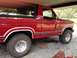 1986 Ford Bronco - Side view of a red 1986 Ford Bronco.