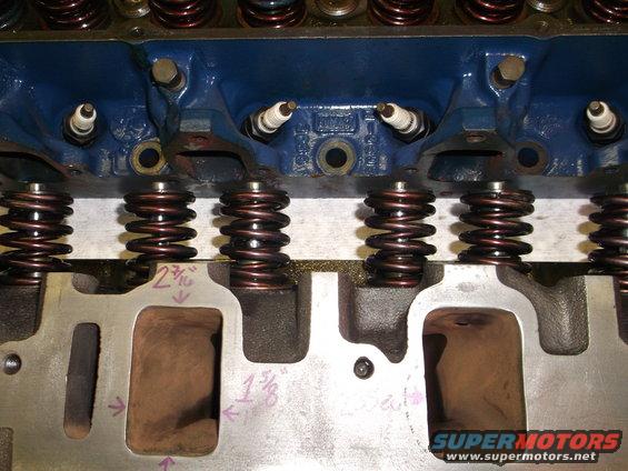 close-up of engine cylinder head with spark plugs and valve springs