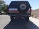 1988 Ford Bronco - Rear view of a 1988 Ford Bronco showing the spare tire and custom bumper.