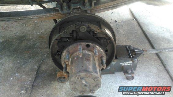 kimg0066.jpg remove the drum. this can be tricky. 

if it wobbles but cant come off then you need to loosen the self adjuster from the back access hole with a flathead screwdriver.

if it wont budge at all then it may be rusted to the hub and tapping may be required to break it free. 