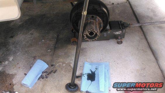 kimg0067.jpg number one: make sure you have enough room to slide the axle shaft out. i made that mystake on the passenger side and had to reassembly everything enough to roll it where i can slide it out

remove the 8 flange bolts and pull the flange out. 

gear oil will come out so be prepared to catch it. the higher the axle is angled the less gear oil that will ooze out.