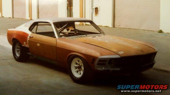 1970 Ford Mustang project car with roll cage, primer and primer patches