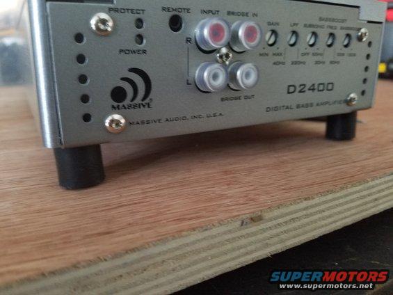 Silver car stereo amplifier with "MASSIVE AUDIO" logo and "D2400 DIGITAL BASS AMPLIFIER" text
