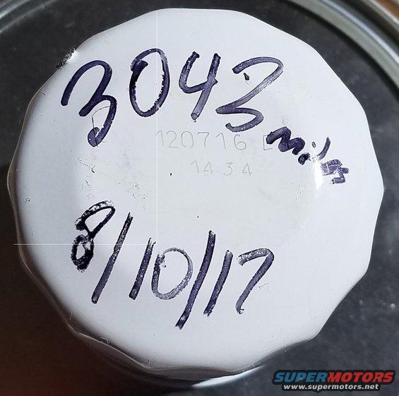 White oil filter with handwritten notes '3043 miles' and '8/10/17'