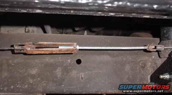 parkbrakecable.jpg Adapting the OE parking brake cable to the Explorer 8.8&quot; cables. A couple pieces of the old cable hardware, some 1/4 - 20 nuts & threaded rod, and some pieces of steel welded together. The threaded rod allows adjustment of the cable tension.