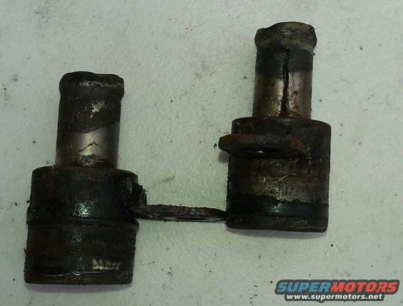 Two rusty metal suspension components, possibly from a car's suspension system