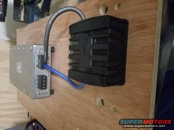 Car stereo amplifier and capacitor mounted on a wooden board