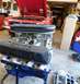 1968 Ford Mustang - Engine with Cobra Le Mans valve covers in front of a red Mustang convertible.