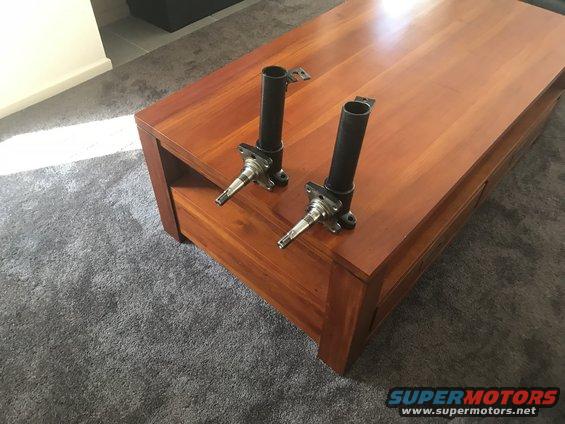 Pair of front wheel hubs on a wooden table