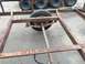 1986 Argo Response - The frame of a rusty trailer is shown, with a single tire and suspension visible.