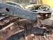 1994 Ford Bronco - Close-up view of a heavily rusted vehicle frame and suspension parts, suggesting a vehicle in disrepair.