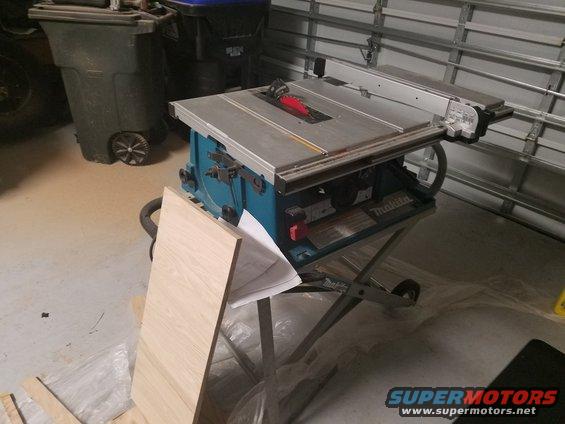 Makita table saw with a piece of wood resting against it