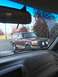 1987 Ford Bronco - This maroon SUV, likely a 1992 Ford Bronco, is seen from inside another vehicle, auxiliary lights on its front bumper.
