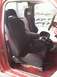 1987 Ford Bronco II - The interior features aftermarket bucket seats with red stitching and a prominent manual transmission shifter, suggesting a performance-ori…