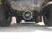 1987 Ford Bronco II - The underside of a vehicle shows its rear axle and differential, with a prominent 'SOLID' marking on the cover.