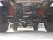 1987 Ford Bronco II - The underside of a vehicle shows its suspension components and drivetrain, with a watermark at the bottom right.
