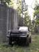 1987 Ford Bronco II - Ford Bronco II parked near a concrete structure with 'USFS 1966' visible.