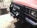 1987 Ford Bronco II - This 1987 Ford Bronco II has a custom front bumper with a winch and light bar. A radiator is visible to the side.