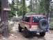 1987 Ford Bronco II - This 1987 Ford Bronco II is seen on a forest trail, equipped with a spare tire and shovel for off-road adventures.