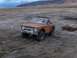 1969 Ford Bronco - A classic Ford Bronco sits in a barren, outdoor environment under a cloudy sky.