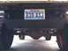 1984 Ford Bronco - The rear of a vehicle is shown, with a license plate prominently displayed.