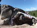 1984 Ford Bronco - Off-road vehicle navigates a rocky terrain, with onlookers observing its precarious position.