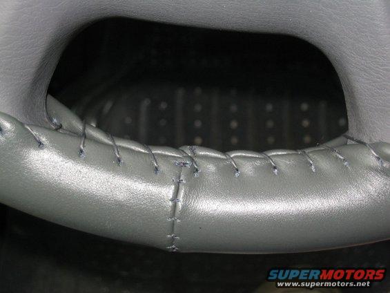 Gray steering wheel with visible stitching