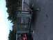 1986 Argo Response - This trailer features a metal cage and a ramp, parked outdoors on a paved surface.