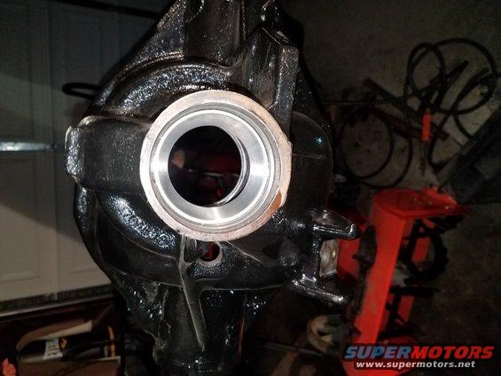 Close-up of a black differential housing with a silver bearing race installed