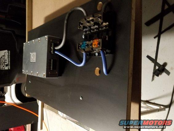 Car stereo amplifier and wiring on a black panel