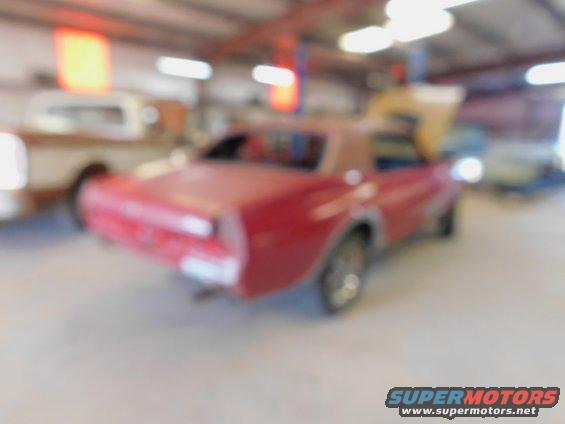1968 Mercury Cougar coupe, red, parked in garage with other vehicles