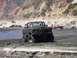 2000 Ford F-450 - Multiple trucks participating in a mud bogging event in a dry riverbed.