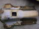 1971 Ford Ranchero - A heavily rusted and damaged metal component, likely a vehicle undercarriage part, lies on a concrete surface.