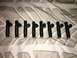 1996 Ford Bronco - A set of eight fuel injectors are displayed on a textured fabric background.