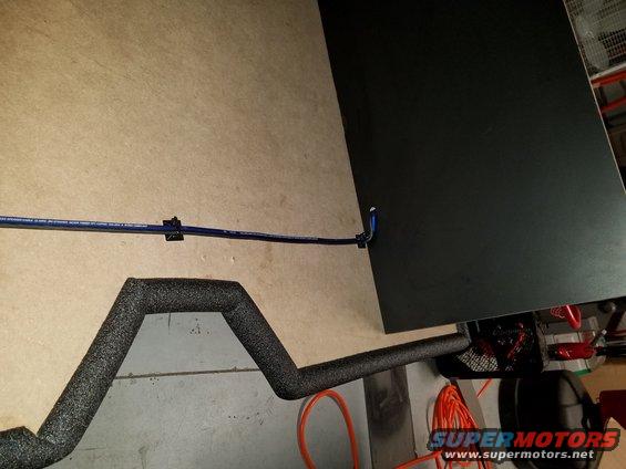 Insulated pipe and blue wiring secured with clips