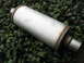 1987 Jaguar XJ6 - A silver Magnaflow muffler rests on a bed of dark green foliage.