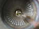 1987 Jaguar XJ6 - View through the perforated interior of a vehicle exhaust pipe, showing greenery beyond.