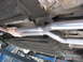 1987 Jaguar XJ6 - The underside of a vehicle shows a newly installed dual exhaust system, including a catalytic converter.