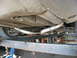 1987 Jaguar XJ6 - Underside view of a vehicle's dual exhaust system, shiny metal pipes and clamps.