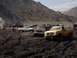 2000 Ford F-450 - Several trucks are participating in a mud bogging event in a hilly, dry area.
