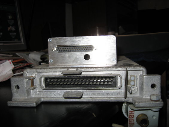 Engine control unit with two connectors and a smaller metal box on top