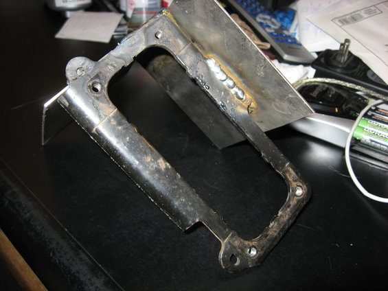 Welded metal bracket with mounting holes
