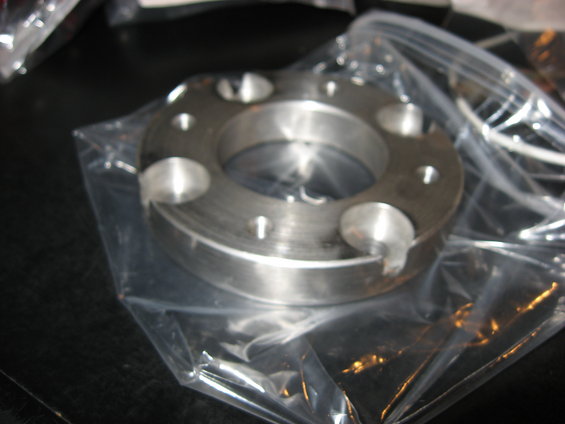 Metal part with bolt holes in plastic packaging