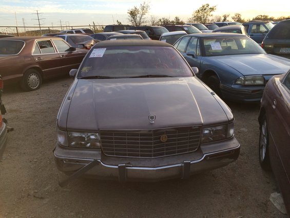 Front view of a gray Cadillac sedan with a prominent grille and hood ornament