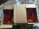 1989 Ford Bronco - A pair of new tail lights are packaged in cardboard boxes, ready for installation.