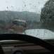 1971 Ford Bronco - Looking out from inside a vehicle at a construction site during a rainstorm.