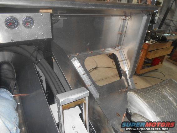 Custom metal fabrication in progress, showing dashboard area with gauges and unfinished console