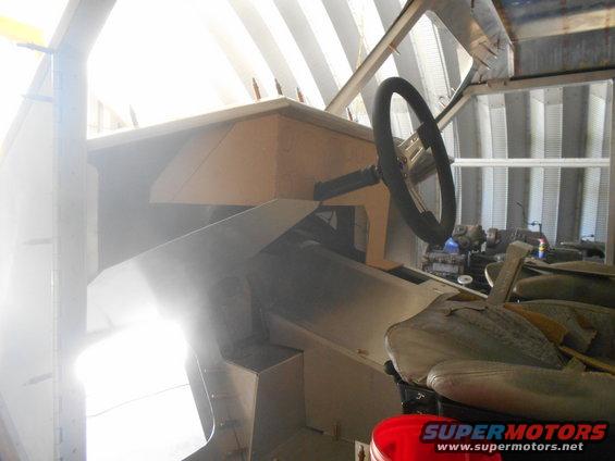 Vehicle interior with a steering wheel, dashboard, and seats, under construction