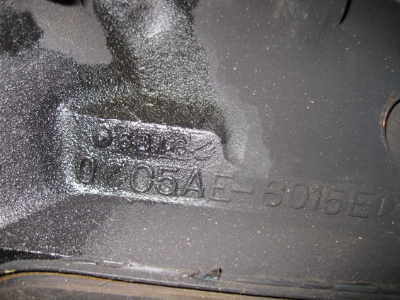 Black engine block with stamped casting numbers D6AE-6015-EA and 0105AE-6015E
